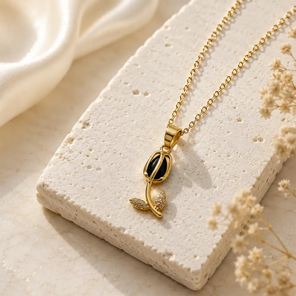Anti tarnish gold floral pendant with black gemstone and crystal leaf design