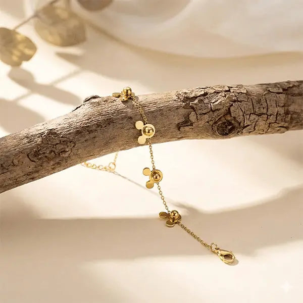 Mini Mouse Bracelet anti-tarnish charm bracelet displayed on natural wooden branch with soft warm lighting