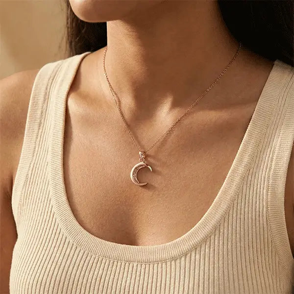 Crescent moon pendant necklace worn on model, rose-gold necklace styled with neutral outfit for everyday elegance