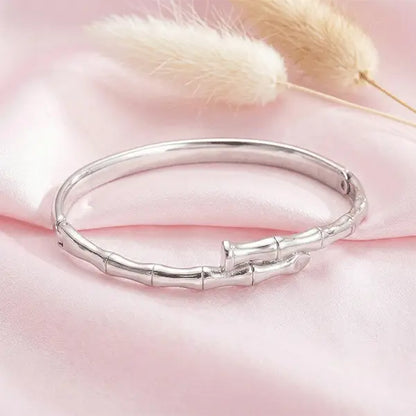 Nail Bracelet anti-tarnish silver-tone bracelet placed on pink satin cloth with dried pampas grass accents