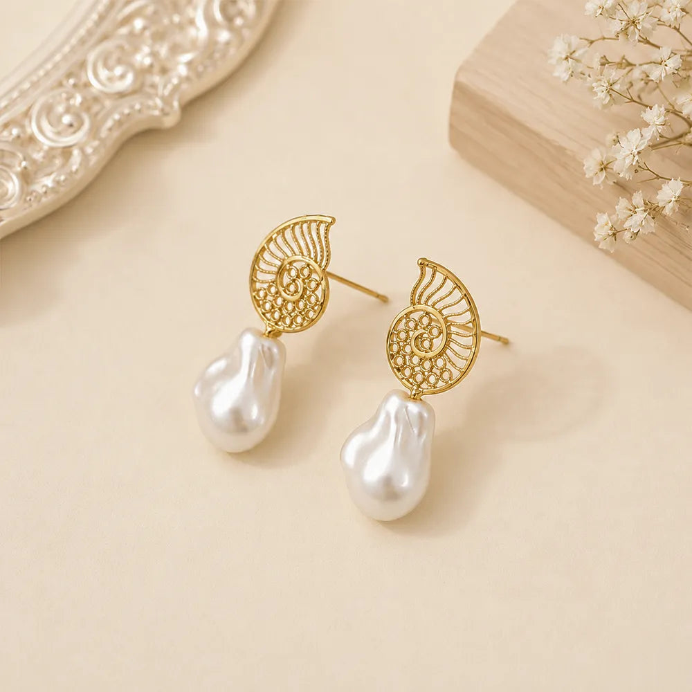 Close-up of Ocean Spiral anti tarnish brass earrings featuring nautical-inspired gold spiral detailing.