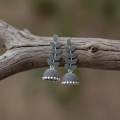 Oxidised silver Pankhuri Jhumkas with a leafy stem design and detailed dome drops.