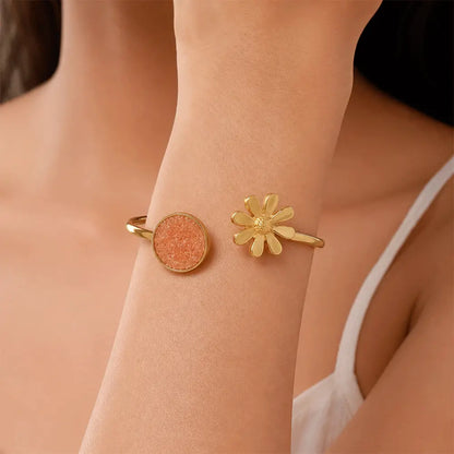 Indian model wearing Peach Blossom anti tarnish brass bracelet featuring a peach druzy stone and daisy flower open cuff design.
