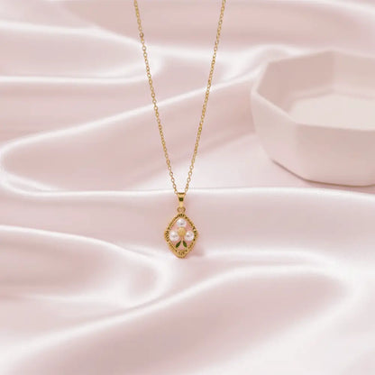 Gold pearl bloom pendant necklace on soft pink satin background, lightweight anti tarnish jewellery