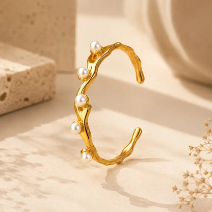 Premium anti tarnish pearl cuff bracelet with luxury beige studio background