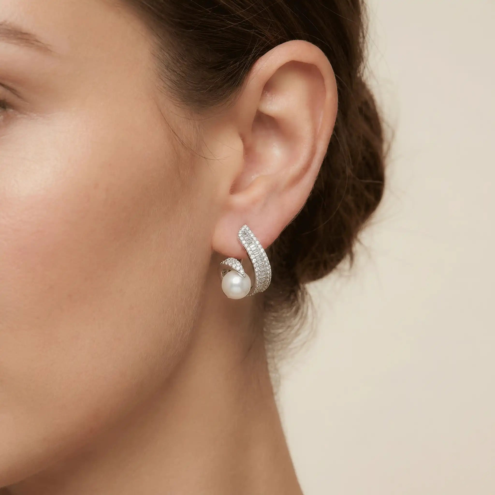 Anti tarnish silver pearl swirl earrings worn on ear for elegant daily wear look