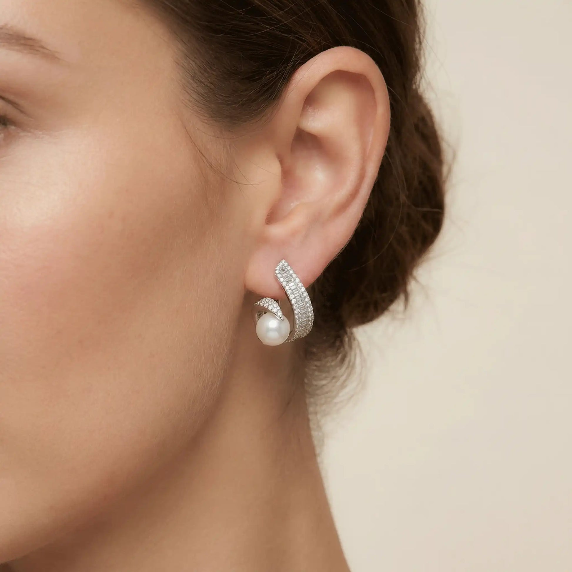 Anti tarnish silver pearl swirl earrings worn on ear for elegant daily wear look