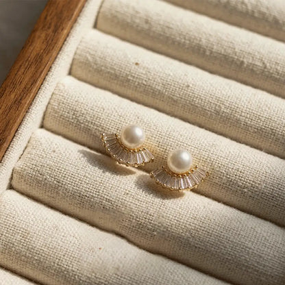 Pearl Fan AD Studs on a textured beige surface
