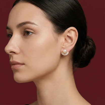 Close-up of a woman wearing Pearl Fan AD Studs against a red background.