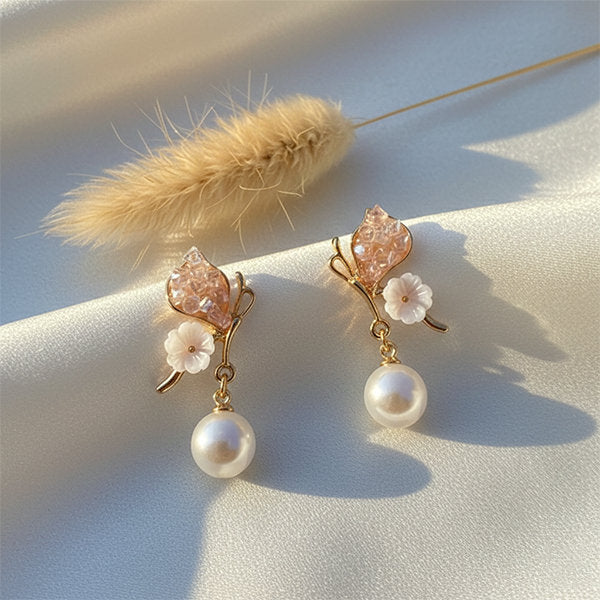 Floral pearl drop earrings with pink crystal petal design