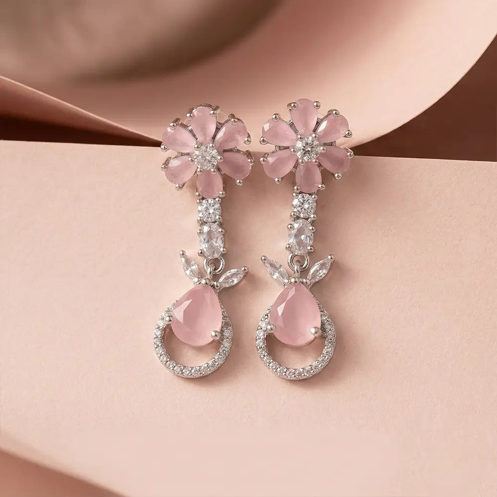 K-A Trends anti tarnish pink floral drop earrings with silver finish and teardrop stone on blush background