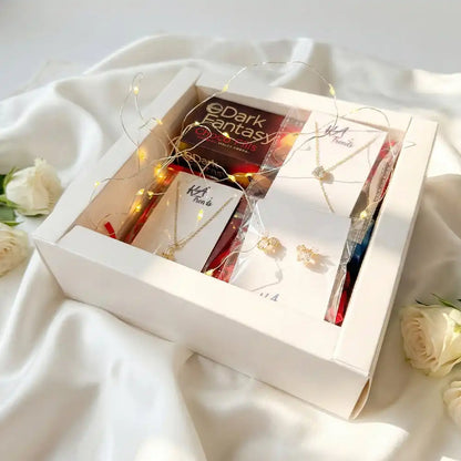 Luxury Valentine jewellery and chocolate gift box with anti-tarnish necklace, earrings, Dark Fantasy Choco Fills, Kitkat and warm fairy lights, styled in an elegant white hamper with roses.