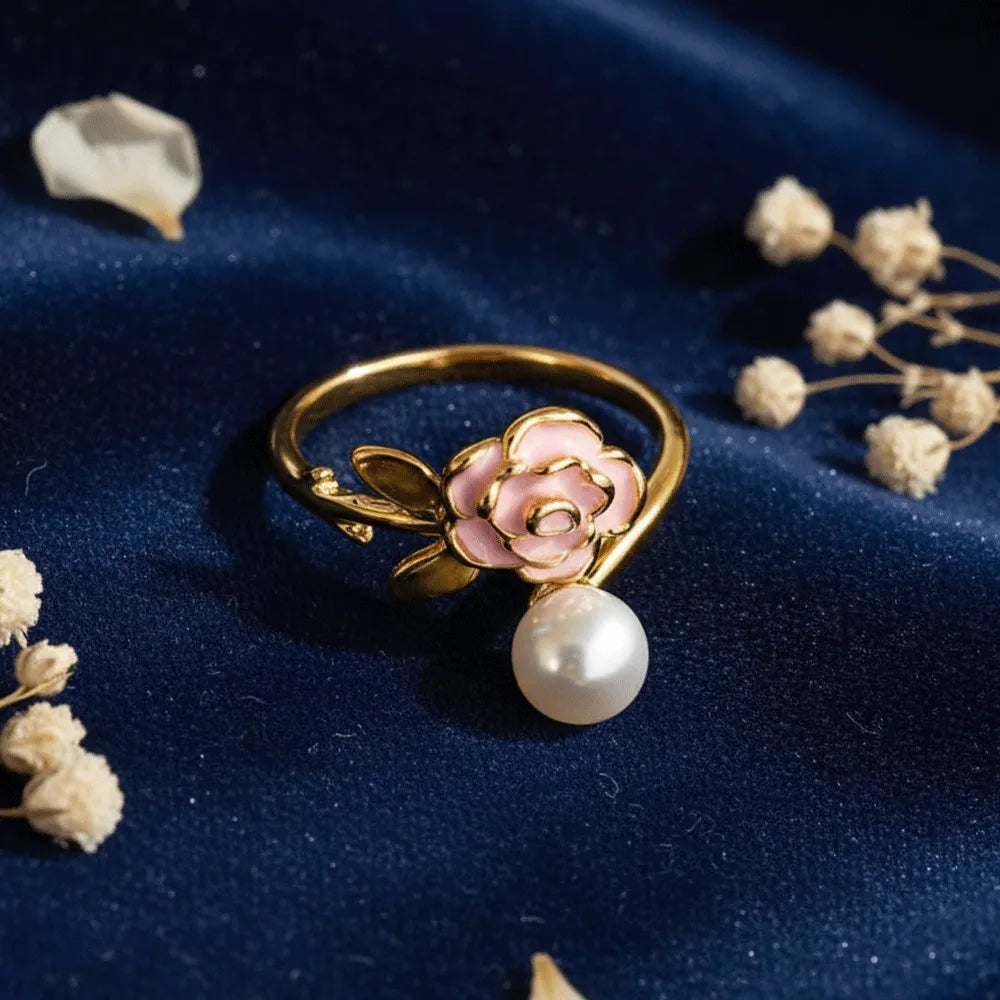 Buy this rose pearl gold ring which has a delicate pink flower with a lustrous pearl set with a adjustable band. 