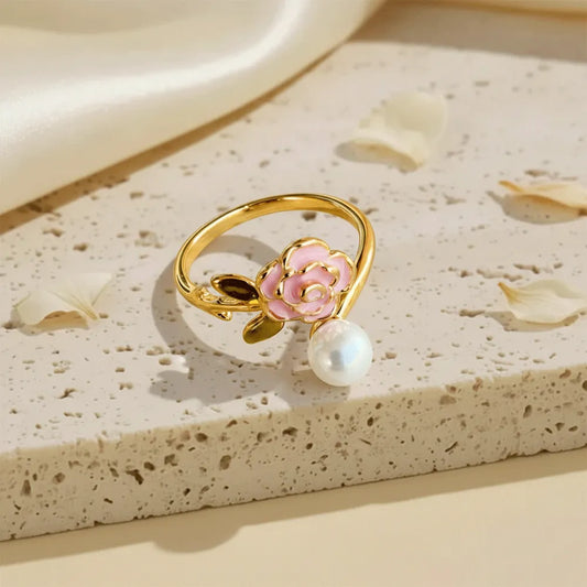 Buy this rose pearl gold ring which has a delicate pink flower with a lustrous pearl set with a adjustable band. 