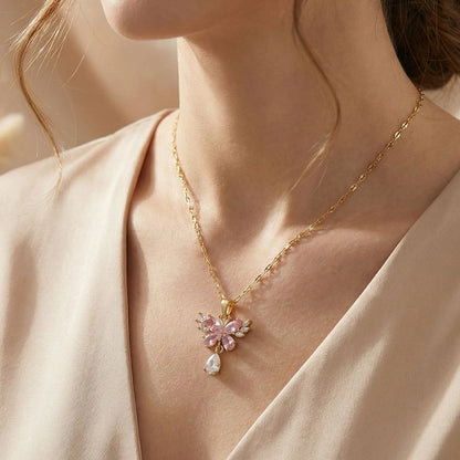 Rose butterfly pendant anti-tarnish necklace worn on model, featuring pink crystals and gold chain