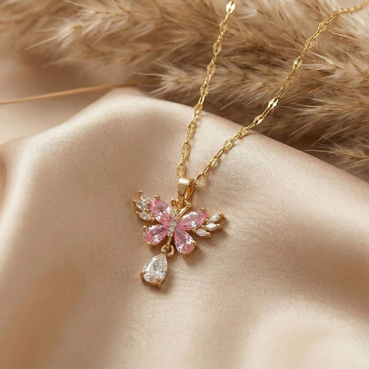 Rose butterfly pendant necklace with pink crystal wings and clear teardrop stone in gold-tone anti-tarnish finish