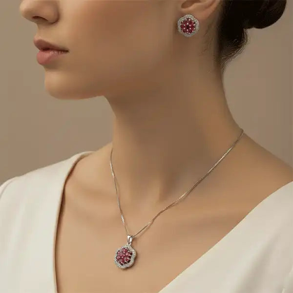 Ruby Bloom Necklace Set worn by model from side angle, ruby pendant necklace and matching earrings