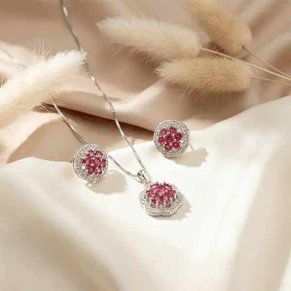 Ruby Bloom Necklace Set close-up on satin background with pampas grass, ruby stone jewellery set