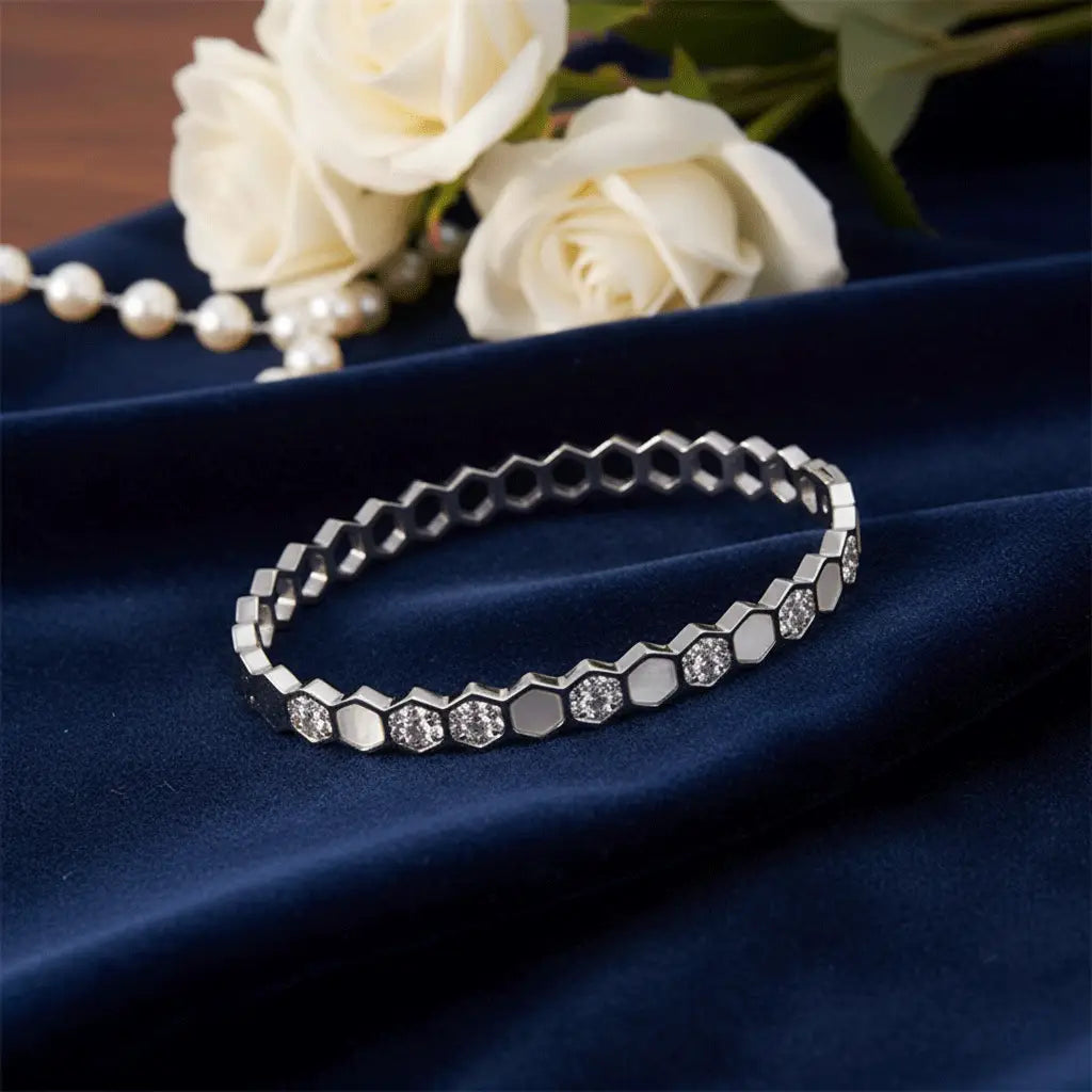 Silver hexagon crystal bracelet placed on navy velvet with white roses – premium anti-tarnish jewellery by K-A Trends.