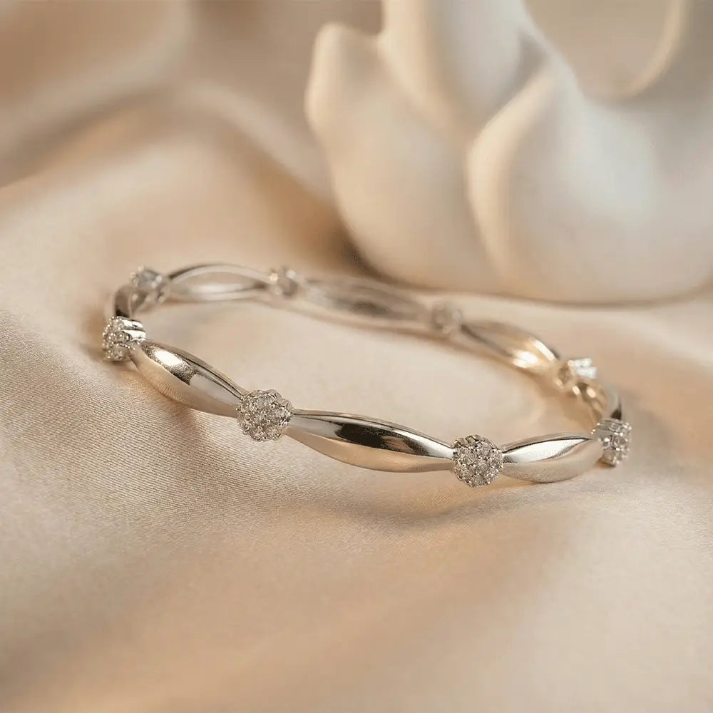 Silver knot AD bangle bracelet with cubic zirconia stones on satin background, anti tarnish jewellery