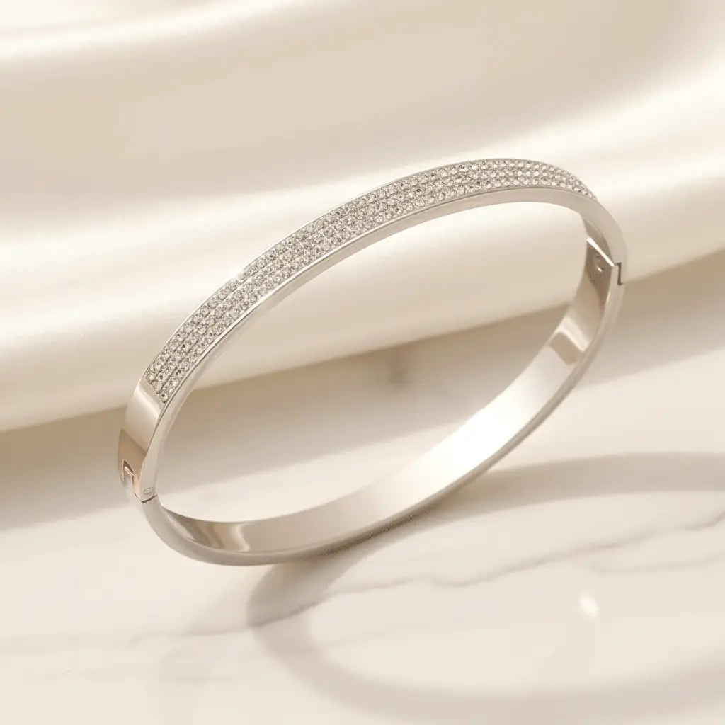 Silver Sparkle Bracelet featuring a sleek micro-pave crystal band displayed on white satin.