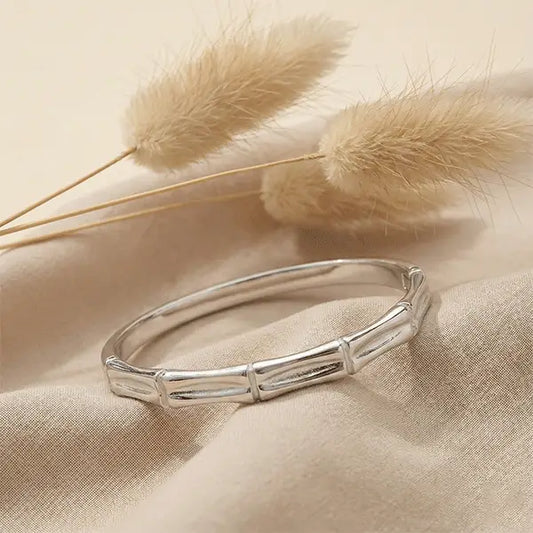 Silver Stack Bracelet anti-tarnish silver-tone bracelet displayed on neutral fabric background with pampas grass accents