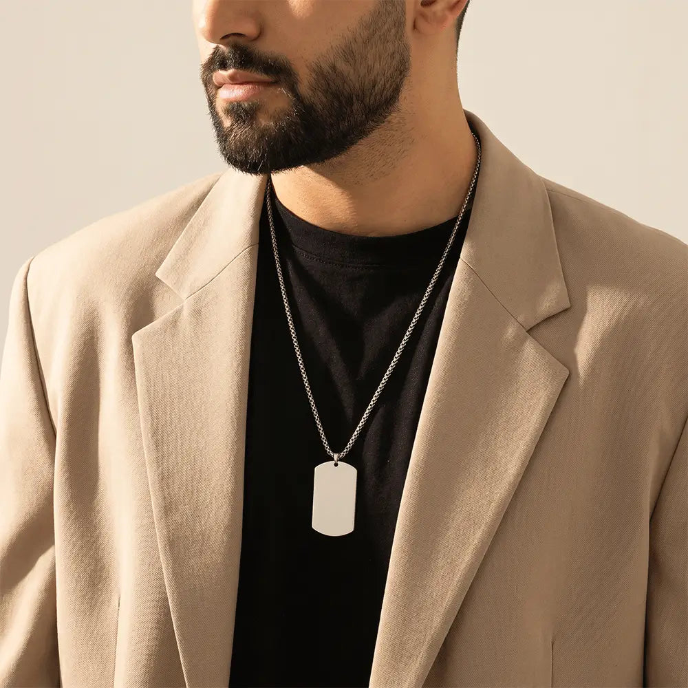 Stylish men’s silver tag pendant necklace paired with beige blazer for modern fashion look from K-A Trends