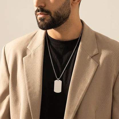 Stylish men’s silver tag pendant necklace paired with beige blazer for modern fashion look from K-A Trends