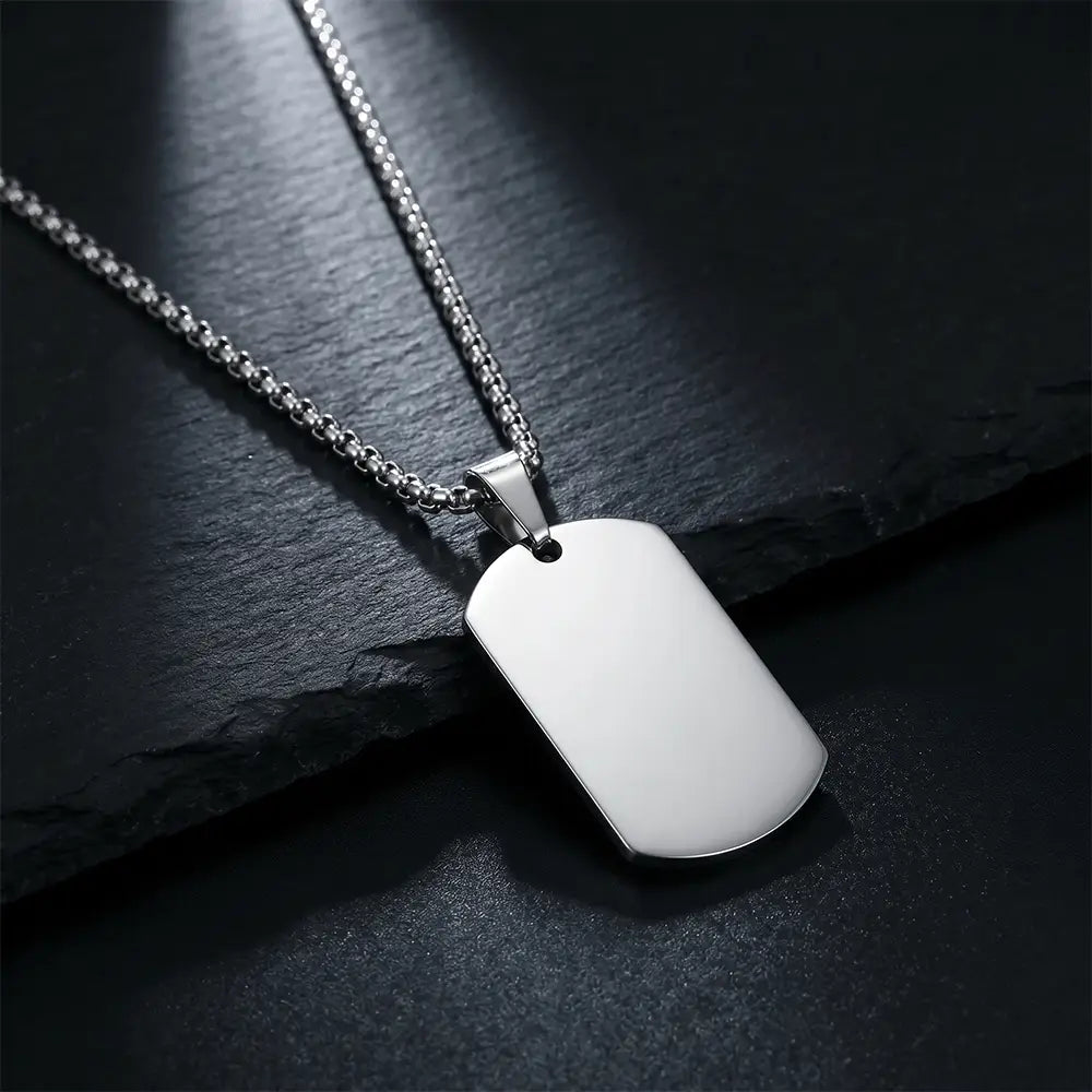 Close-up of premium silver anti-tarnish tag pendant necklace on black textured background by K-A Trends