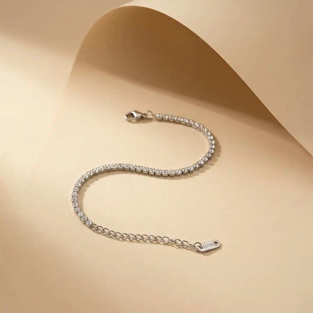 K-A Trends anti tarnish silver tennis bracelet with cubic zirconia stones and adjustable extension chain on beige background