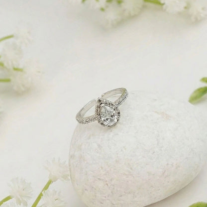 Silver Teardrop ring with a diamond on a white stone surrounded by white flowers