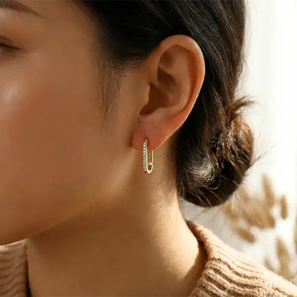 Anti-tarnish gold soft bling hoop earrings worn on a woman’s ear, minimalist zircon stone hoops for everyday wear