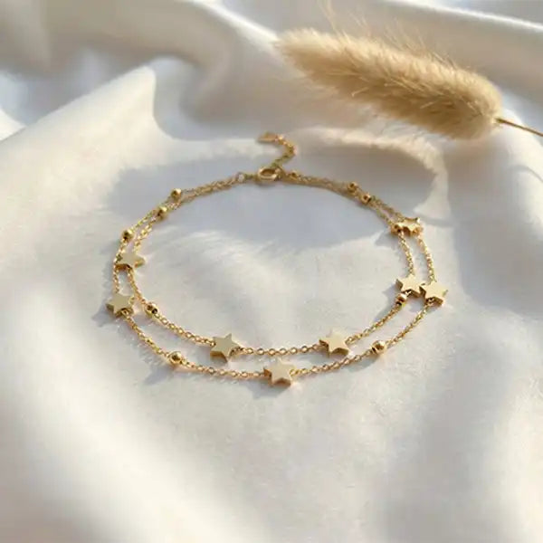 Star Layer Bracelet anti-tarnish gold layered star bracelet on white satin background