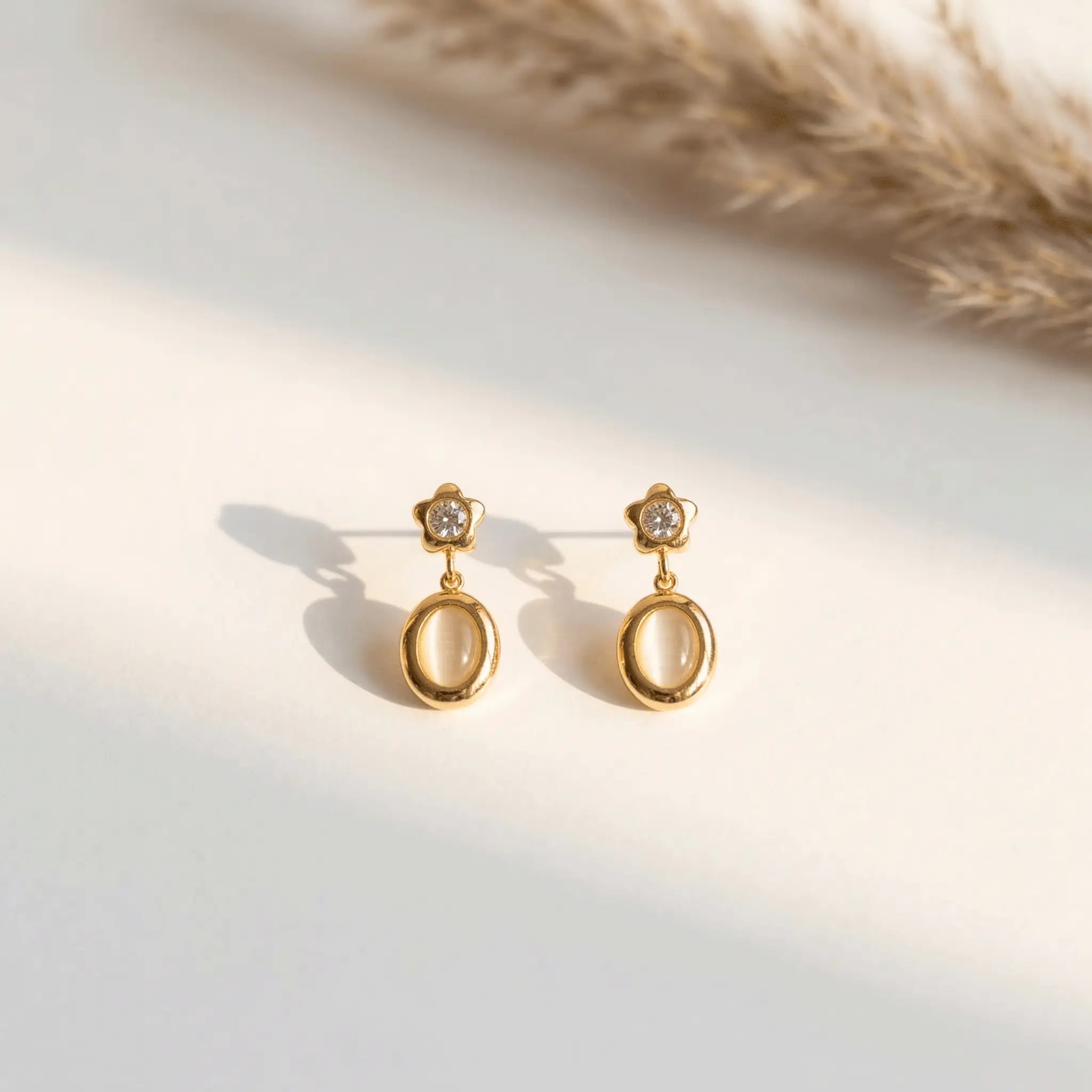 Star Spark Oval Drops with gemstones on a light background