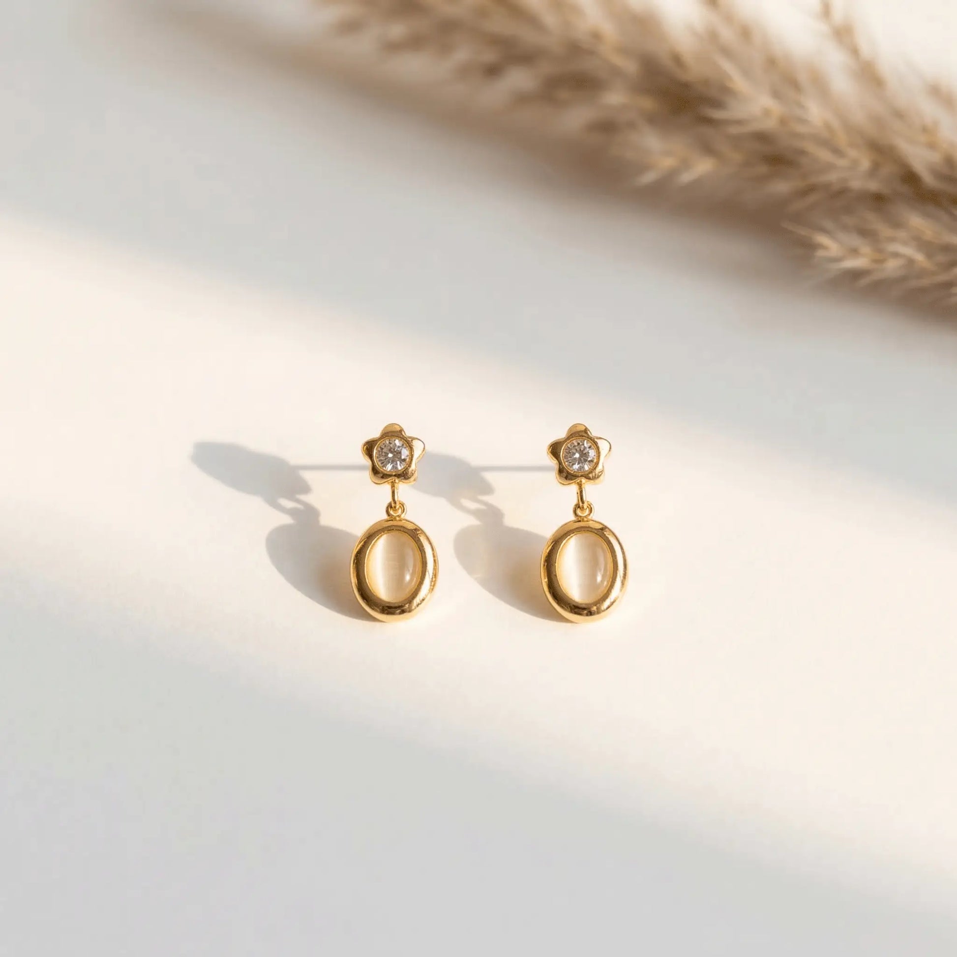 Star Spark Oval Drops with gemstones on a light background