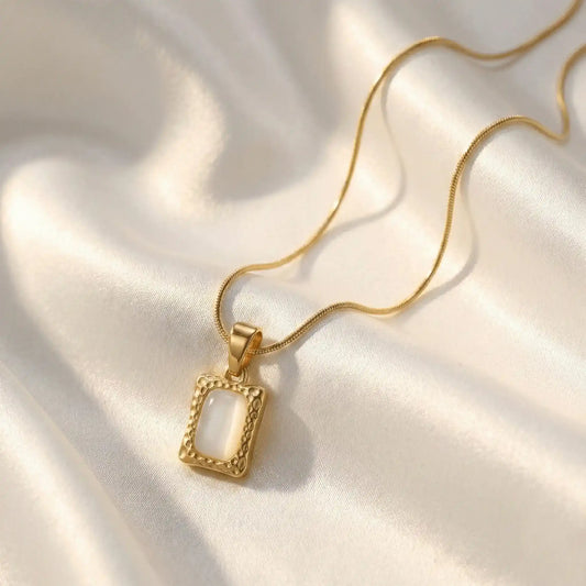 Stone Frame Pendant anti-tarnish gold stone pendant necklace on white satin fabric