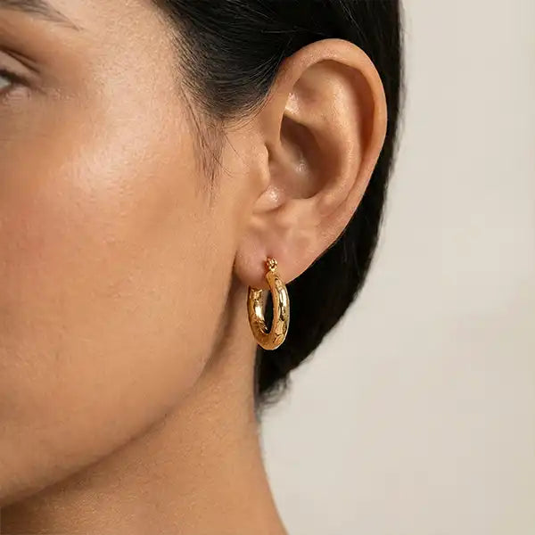 Textured Gold Bali Hoop Earrings worn by model in ear close-up