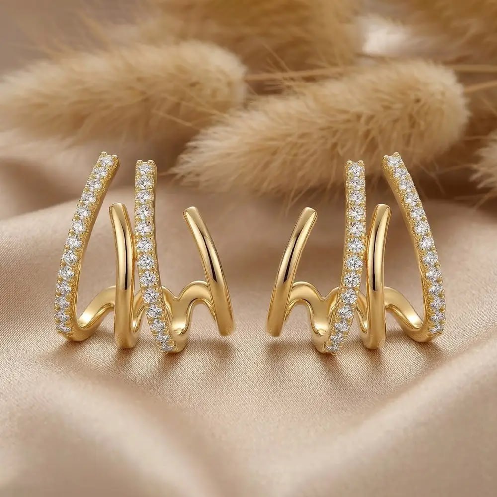 Triple Spike AD Studs with diamond accents on a beige fabric background