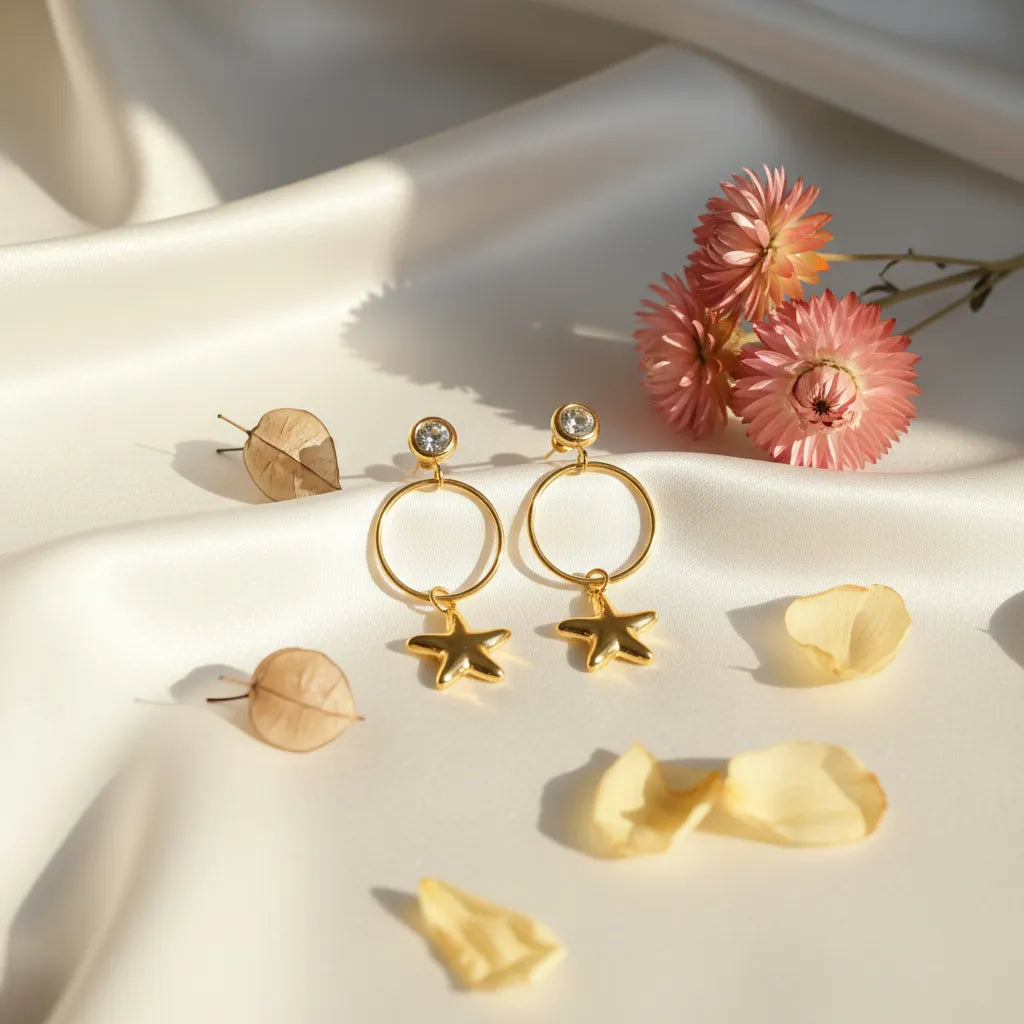 Twinkle Star Drops on a soft fabric background with flowers and petals.