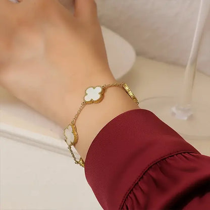 White Clover Bracelet worn on wrist with gold tone finish and white clover charm, elegant everyday jewellery styling